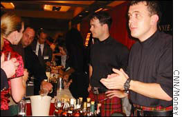 Whiskey connoisseurs enjoy a tasting at the Johnnie Walker table at WhiskyFest, 2003.