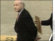 Former Enron CEO Kenneth Lay being led in handcuffs to the U.S. courthouse in Houston Thursday.
