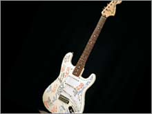 You could be the owner of this guitar signed by such luminaries of high finance as Warren Buffett and George Soros.