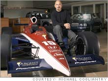 Rahal in the Wexford, Pa. showroom, where he sells Jaguars, Land Rovers and Volvos, with a model of a Rahal Letterman Indy car.