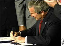 President Bush signs the corporate reform bill into law at the White House.
