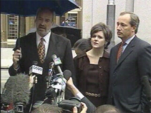 Former WorldCom controller David Myers (right) listens with his wife, Carla, as his attorney Richard Janis (left) makes a statement outside of federal court in New York. (Photo: CNNfn)